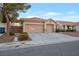 Two-car garage and front yard with desert landscaping at 5851 Flight Wing St, Las Vegas, NV 89113