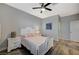 Bedroom with a white queen-size bed, ceiling fan, and gray walls at 6297 Starflare St, Las Vegas, NV 89148