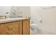 Clean bathroom with wood cabinets, a toilet and shower at 6623 Topley Pike Ave, Las Vegas, NV 89139