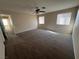 Large bedroom with carpet, ceiling fan and access to hallway at 9421 Amber Valley Ln, Las Vegas, NV 89134