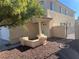 Two-story house with a tan exterior, entryway, and a small landscaped area at 9421 Amber Valley Ln, Las Vegas, NV 89134