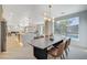 Modern dining area with table and chairs, overlooking backyard pool at 10981 Laureldale Ct, Las Vegas, NV 89141