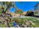 Relaxing water feature with lush landscaping and a stone pond at 10981 Laureldale Ct, Las Vegas, NV 89141