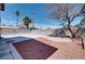 Backyard features a large concrete patio and gravel landscaping at 1806 Renada Cir, North Las Vegas, NV 89030