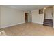 Open living room with tiled floors and a staircase at 1806 Renada Cir, North Las Vegas, NV 89030