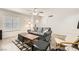 Living room featuring gray couch, wood-look floors, and a ceiling fan at 2433 Olivewood St, Las Vegas, NV 89108