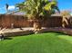 Landscaped backyard with artificial turf and a curved retaining wall at 5909 Mount Auburn St, Las Vegas, NV 89130