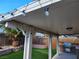 Covered patio with string lights, built-in BBQ, and artificial turf at 5909 Mount Auburn St, Las Vegas, NV 89130