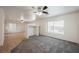 Spacious living room with gray carpeting and ceiling fan at 7466 Mission Palm St, Las Vegas, NV 89139