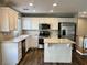 Modern kitchen with white cabinets, island, and stainless steel appliances at 8965 Michael Ryan Ct, Las Vegas, NV 89149