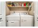 Laundry room with washer, dryer, and storage shelving at 1071 Nordyke Ave, Henderson, NV 89015