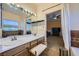 Elegant bathroom with double sinks, a vanity, and views into the bedroom at 1808 Cedar Bluffs Way, Las Vegas, NV 89128