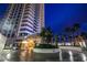 Luxury high-rise building at night with palm trees and circular driveway at 2700 Las Vegas Blvd # 610, Las Vegas, NV 89109