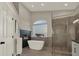 Relaxing bathroom with soaking tub, glass shower, and block window at 2721 Crystal Beach Dr, Las Vegas, NV 89128