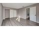 Well-lit bedroom with wood-look floors and mirrored closet doors at 352 Dockside Ct, Las Vegas, NV 89145