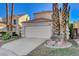 Two-story house with attached garage and desert landscaping at 352 Dockside Ct, Las Vegas, NV 89145