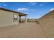 Gravel backyard with covered patio, seating area, and block wall at 372 Cooper Hawk Ct, Las Vegas, NV 89138