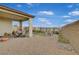 Spacious backyard with covered patio, gravel, and seating areas at 372 Cooper Hawk Ct, Las Vegas, NV 89138