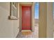 Close-up of the red front door with a welcome mat at 372 Cooper Hawk Ct, Las Vegas, NV 89138