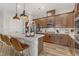 Modern kitchen with wood cabinets, quartz counters and island with seating at 372 Cooper Hawk Ct, Las Vegas, NV 89138