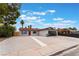 Newly renovated home with a red door and gravel driveway at 4621 Kathleen Ct, Las Vegas, NV 89110