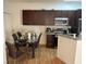 Eat-in kitchen with dark wood cabinets and a glass dining table at 5162 S Jones Blvd # 105, Las Vegas, NV 89118