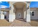 Covered entryway with brick flooring, arched entry, and elegant light fixtures at 5290 Fairmont St, Pahrump, NV 89061