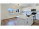 Modern kitchen with white cabinets, island, and stainless steel appliances at 5290 Fairmont St, Pahrump, NV 89061