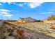 Large backyard with a view of the house and surrounding desert landscape at 5471 Lincolnwood Ct, Pahrump, NV 89061