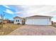 New construction home with a two-car garage and paver driveway at 5471 Lincolnwood Ct, Pahrump, NV 89061