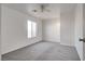 Bright bedroom with grey carpet, ceiling fan, and window at 6439 Wadsworth Ct, Las Vegas, NV 89156