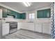 Galley kitchen with stainless steel appliances and green cabinets at 6439 Wadsworth Ct, Las Vegas, NV 89156