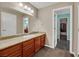 Modern bathroom with a granite countertop, large vanity, and a view into another room at 647 Foxhall Rd, Henderson, NV 89002