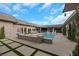 Inviting pool area with stone accents and string lights at 647 Foxhall Rd, Henderson, NV 89002