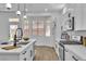 Modern kitchen featuring white cabinets, black appliances, and an island with sink at 10301 Long Leaf Pl, Las Vegas, NV 89134