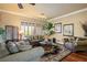 Comfortable living room featuring hardwood floors, a ceiling fan, and large windows at 10600 Cedar Creek Ave, Las Vegas, NV 89134