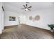 Living room with wood-look floors and neutral wall decor at 10901 Black Ledge Ave, Las Vegas, NV 89134