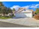 Single story house with a two-car garage and nicely landscaped yard at 2009 Cedar Hills St, Las Vegas, NV 89128