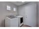 Laundry room with washer, dryer, and ample shelving at 3554 Cherbourg Ave, Las Vegas, NV 89141