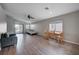 Open living area with gray couch, dining area, and wood-look flooring at 3554 Cherbourg Ave, Las Vegas, NV 89141