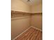 Large walk-in closet with wood-look floors and double hanging rods at 5236 Ladyhawk Way, Las Vegas, NV 89118