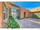 Home's entryway with a courtyard and lush landscaping at 6695 Regency Stone Way, Las Vegas, NV 89148