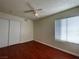 Bedroom with wood floor, ceiling fan and window coverings at 6939 Paddington Way, Las Vegas, NV 89147