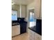 Kitchen with white cabinets, black countertops, and pool view at 6939 Paddington Way, Las Vegas, NV 89147