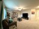 Spacious bonus room with TV, couch, and ample storage at 7156 Woodrow Ranch St, Las Vegas, NV 89166