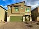 Two-story house with green garage door and paved driveway at 7156 Woodrow Ranch St, Las Vegas, NV 89166