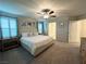 Bright main bedroom with king bed and ensuite bathroom at 7156 Woodrow Ranch St, Las Vegas, NV 89166