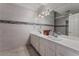 Double vanity bathroom with light grey tile and modern fixtures at 7720 W Agate Ave, Las Vegas, NV 89113