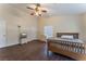 Spacious bedroom with wood flooring, a ceiling fan, and a dresser at 7720 W Agate Ave, Las Vegas, NV 89113