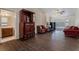 Spacious living room with dark wood floors, a view of the bathroom, and comfortable seating at 7720 W Agate Ave, Las Vegas, NV 89113